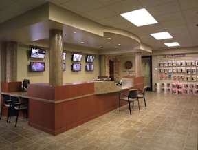 A reception area with a counter and chairs.