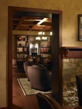 A room with a brown chair and a brown ottoman.