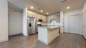 A kitchen with a refrigerator, microwave, and oven at Railside at Wadsworth Station, Lakewood, 80214