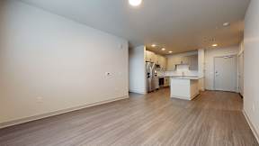A spacious room with a kitchen area in the background at Railside at Wadsworth Station, Lakewood, 80214