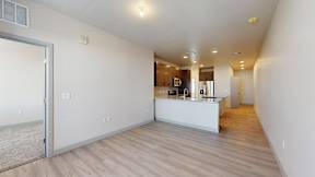 A spacious room with a kitchen area in the background at Railside at Wadsworth Station, Lakewood, 80214