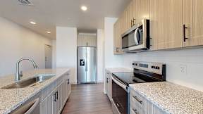 A kitchen with a sink, stove, and refrigerator at Railside at Wadsworth Station, Lakewood, 80214
