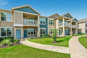 A row of houses with blue doors and windows.