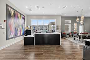 A modern office space with a large abstract painting on the wall.