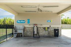 A gas station with a blue sign that says "BP Gas" and a yellow sign that says "Exxon.".