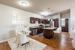 A kitchen with a table and chairs in the middle of the room.