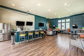 A modern kitchen with a long table and chairs.