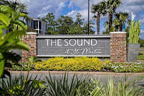 A sign that says "The Sound" is in front of a building.