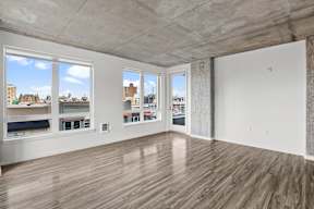 A room with a view of the city through the windows.