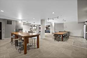 A modern dining area with a long wooden table and chairs.