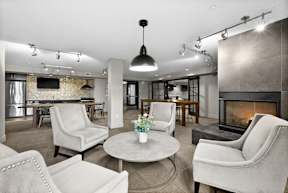 A living room with a fireplace and a dining table.