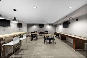 A conference room with a long table and chairs.