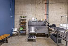 A kitchen area with a table, chairs, and a sink.