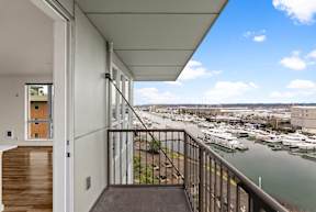A balcony with a view of a marina.