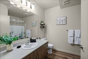 A bathroom with a white sink and a white toilet.