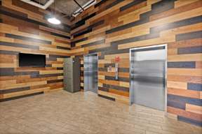 A room with wooden walls and a metal door.