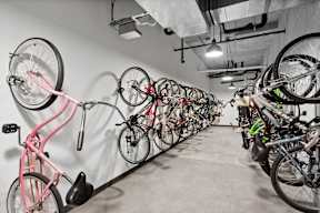 A bike rack with many bikes hanging on it.