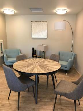 A modern living room with a large fan and a couch.
