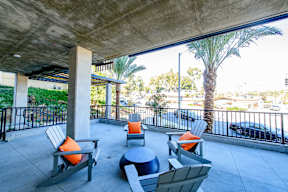 A patio with a table and chairs under a roof.