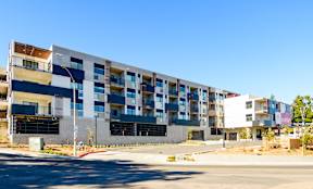 A large multi-story building with balconies and windows.