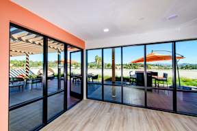 A room with a glass wall and a wooden floor.