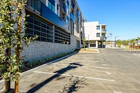 A parking lot with a building in the background.