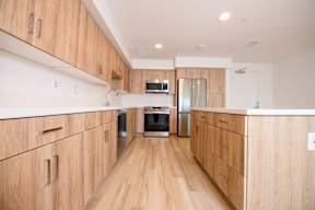 A kitchen with wooden cabinets and stainless steel appliances.