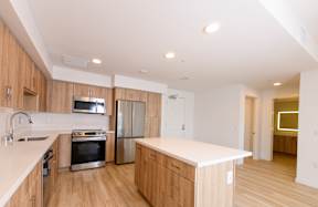 A kitchen with wooden cabinets and stainless steel appliances.
