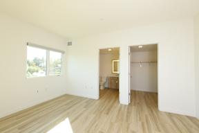 A room with a wooden floor and white walls.
