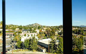 A view of a town from a window with buildings and trees.