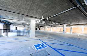 A parking garage with a handicap parking spot.