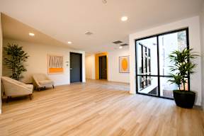 A room with wooden floors and a large window.