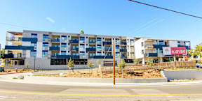 A large multi-story building with a blue and white facade.