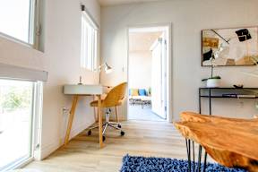 A room with a desk and a chair.