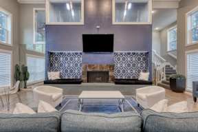 A modern living room with a fireplace and a television.