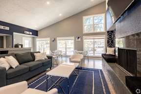 A living room with a grey couch and a white coffee table.