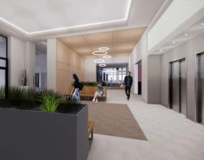 A modern hallway with people walking and sitting.
