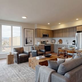 A modern living room with a grey couch and a wooden coffee table.