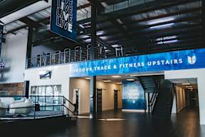 A gym with a sign that says "Live Work Play".