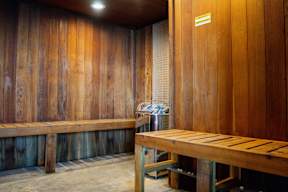 A room with wooden walls and a bench.