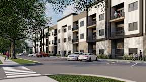 A street view of a residential area with cars and a pedestrian.