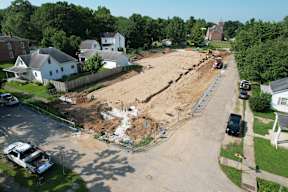 A construction site is in the middle of a residential street.