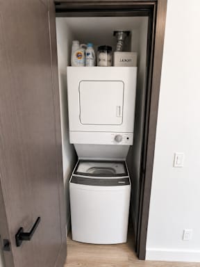 A small laundry room with a washer and dryer.