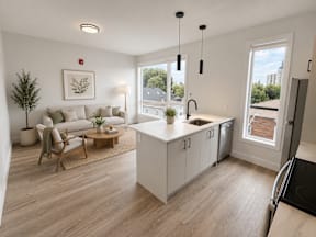 A modern kitchen with a white cabinetry and a wooden floor.