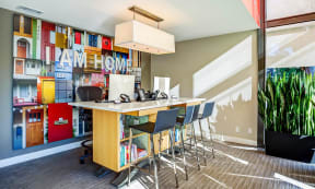 a long bar with chairs in front of a book shelf