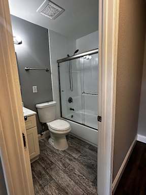 a bathroom with a toilet and a shower