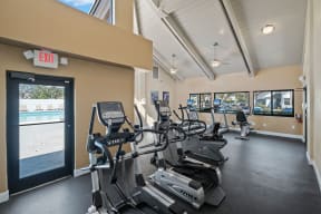 gym with cardio equipment at the whispering winds apartments in pearland, tx