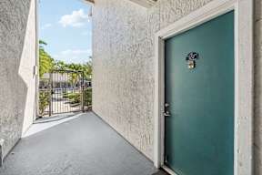 A green door with a number 307 on it is closed.