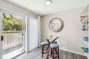 A dining room with a glass table and chairs.