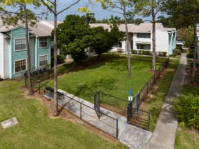 a fenced in yard with houses in the background